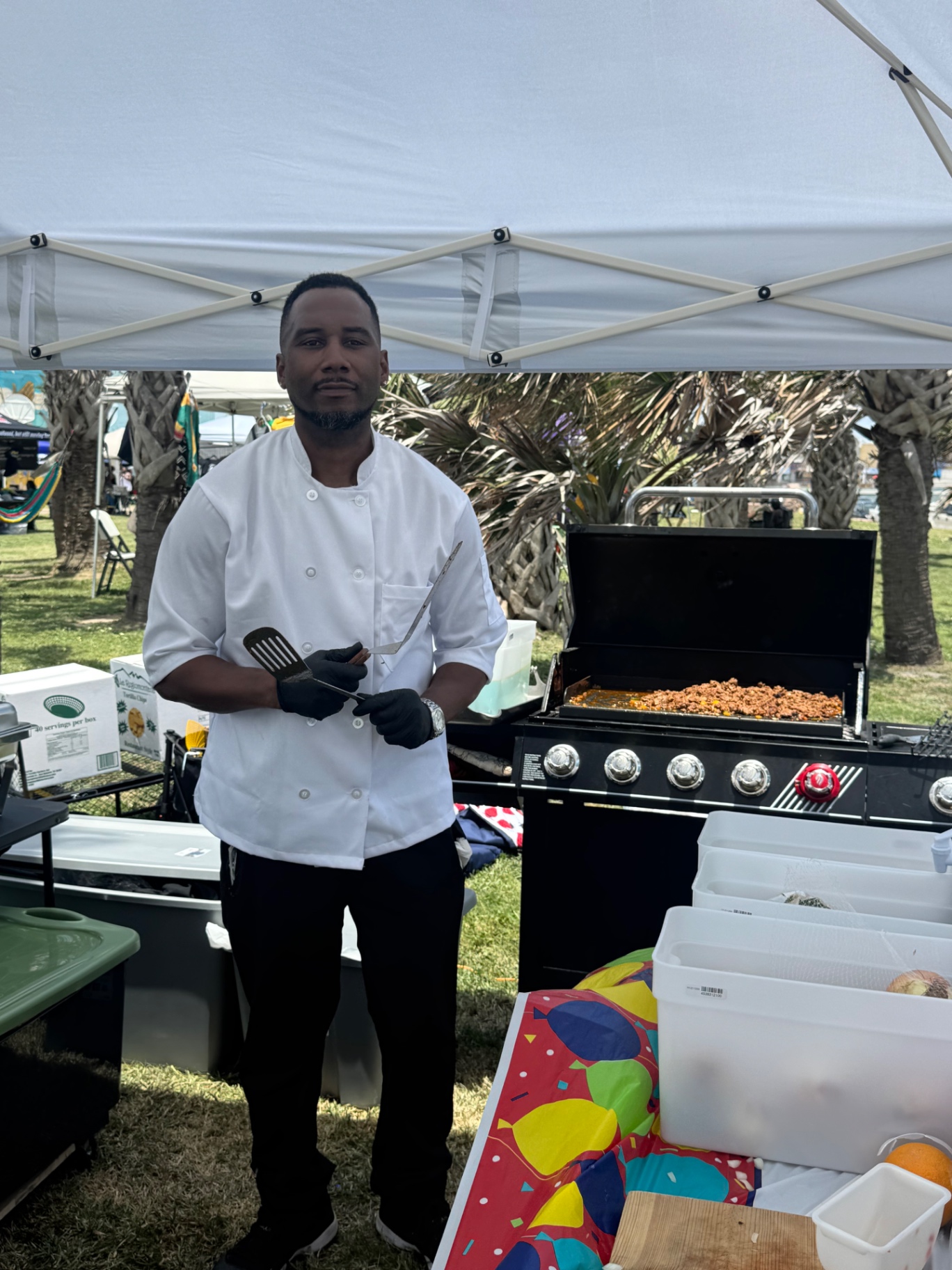 Arthur Bolton in chef whites at a True Growth catering tent